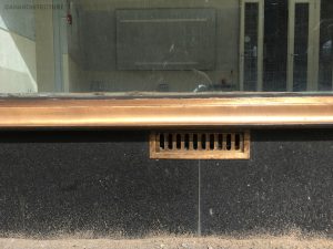 Cleaned and repaired bronze sill detailing, granite stall riser and vent grille